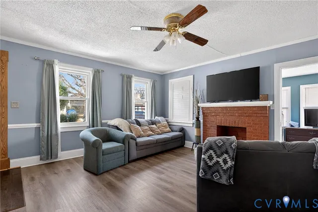 a living room with furniture a fireplace and a flat screen tv