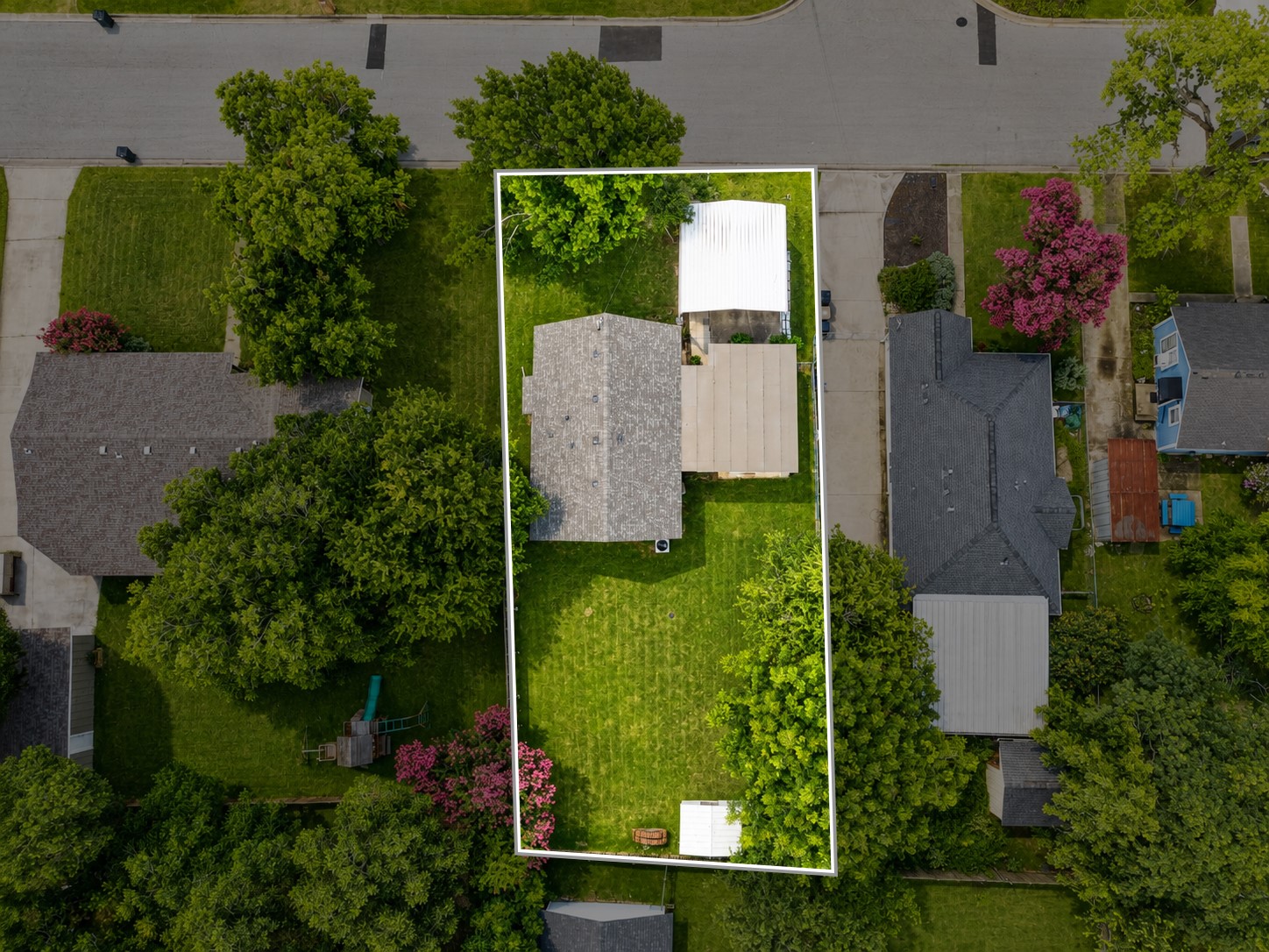 1508 Walnut Street Georgetown, TX 78626 - Photo 3 of 37 An aerial perspective reveals a well-maintained property with a verdant lawn and mature trees.