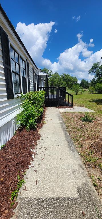 19865 Southwest 5th Place Dunnellon, FL 34431 - Photo 6 of 78 a view of a house with backyard and garden