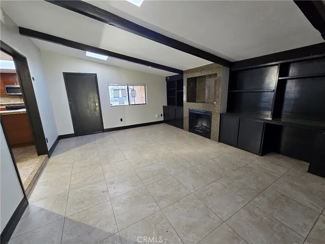 a view of an empty room with a fireplace