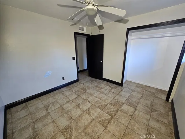 a view of a hallway with a chandelier fan and entryway