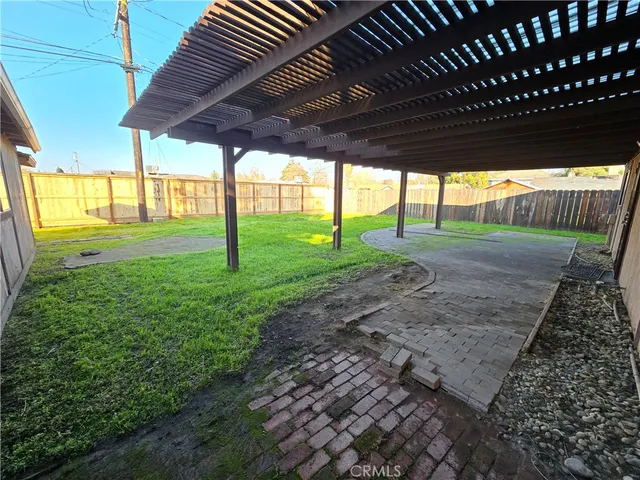 a view of a backyard with a swing chair and table