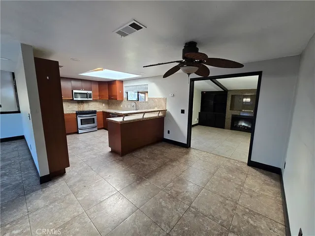 a kitchen with stainless steel appliances granite countertop a refrigerator and a sink