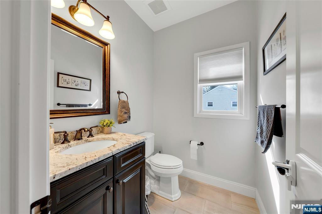 51 Terrace Street Park Ridge, NJ 07656 - Photo 13 of 29 a bathroom with a granite countertop sink toilet and shower