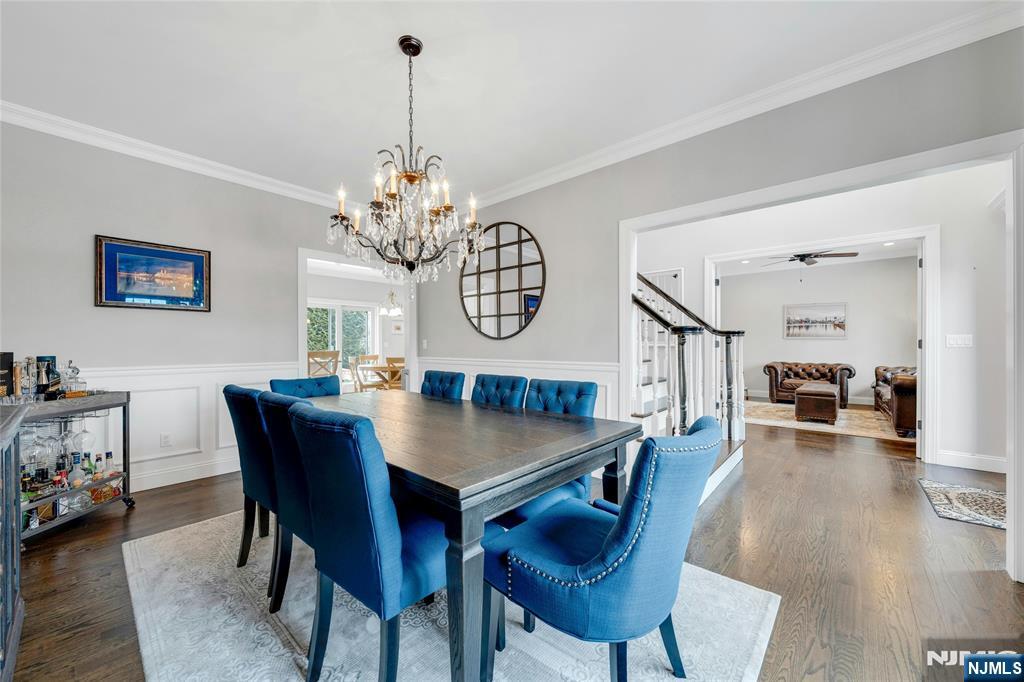 51 Terrace Street Park Ridge, NJ 07656 - Photo 10 of 29 a dining room with wooden floor a chandelier a wooden table and chairs