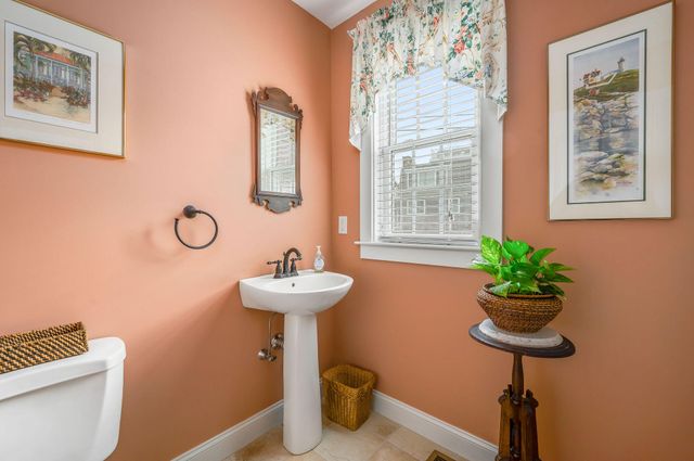 a bathroom with a sink toilet and a mirror