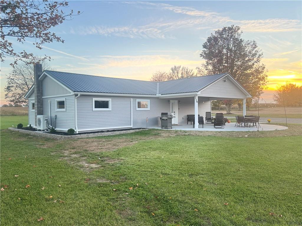 a front view of a house with a garden and yard