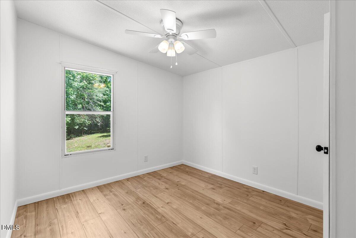 1111 Stoney Mountain Road Rougemont, NC 27572 - Photo 12 of 30 wooden floor in an empty room with a window