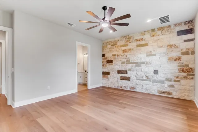 a view of a livingroom with a ceiling fan wooden floor and a ceiling fan