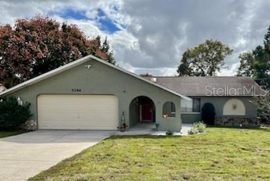 5286 Birchwood Road Spring Hill, FL 34608 - Photo 1 of 1 a front view of a house with a yard