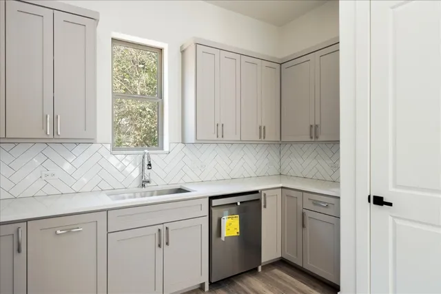a kitchen with a sink cabinets and window