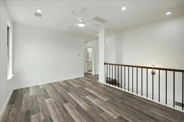 a view of a room with wooden floor