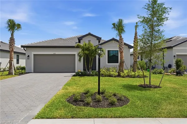 a front view of a house with a yard and garage