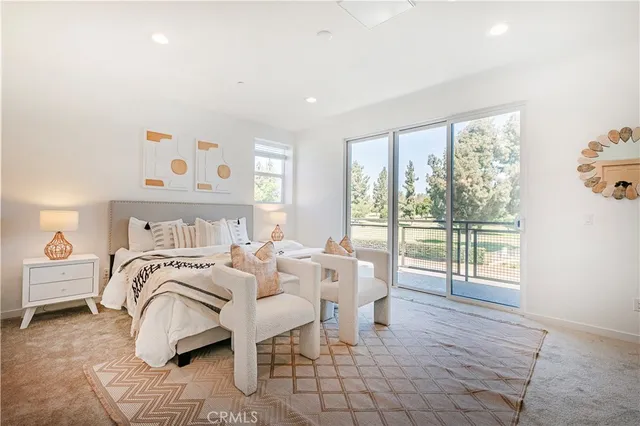 a spacious bedroom with a bed and a large window