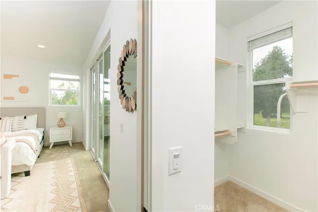 a view of a bedroom with a bed and a window