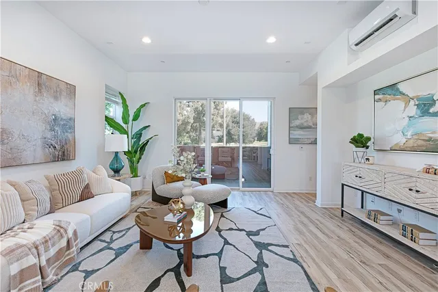 a living room with furniture and window with potted plants