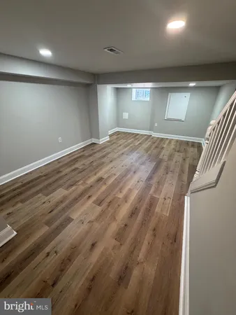 an empty room with wooden floor