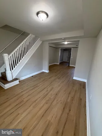 a view of an empty room and wooden floor