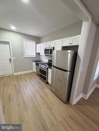 a kitchen with stainless steel appliances a refrigerator sink and microwave