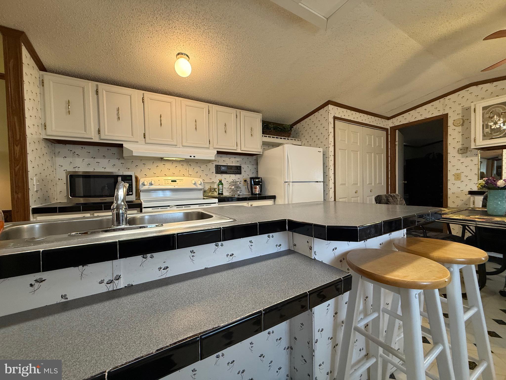 114 Pheasant Ridge Circle Lancaster, PA 17603 - Photo 11 of 30 a kitchen with stainless steel appliances a sink a stove a refrigerator and cabinets
