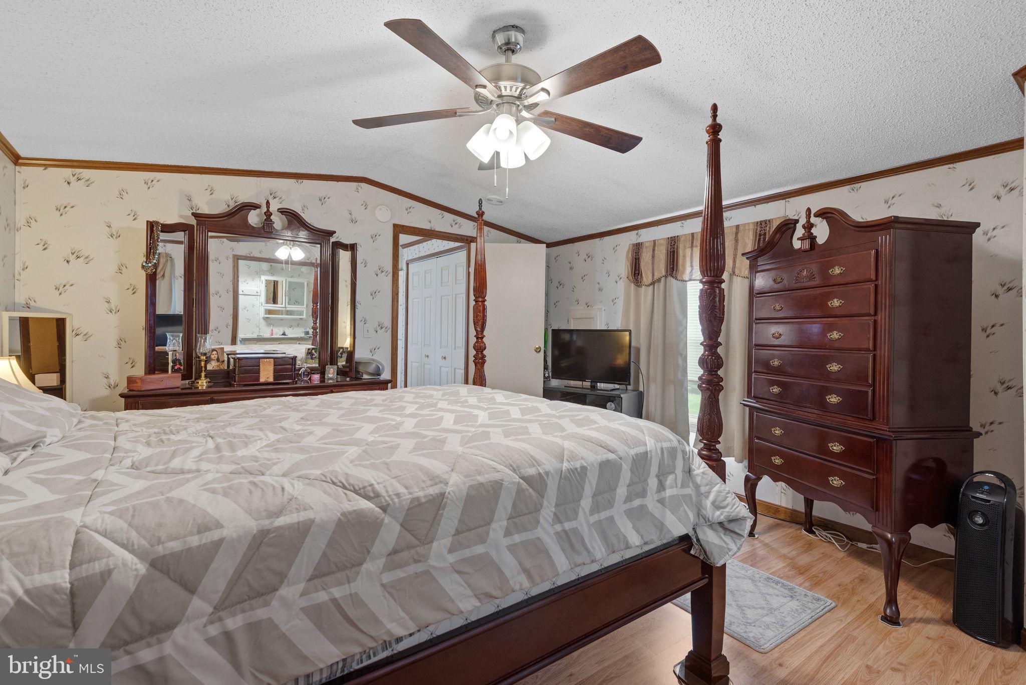 114 Pheasant Ridge Circle Lancaster, PA 17603 - Photo 15 of 24 a bedroom with a bed a dresser and a chandelier