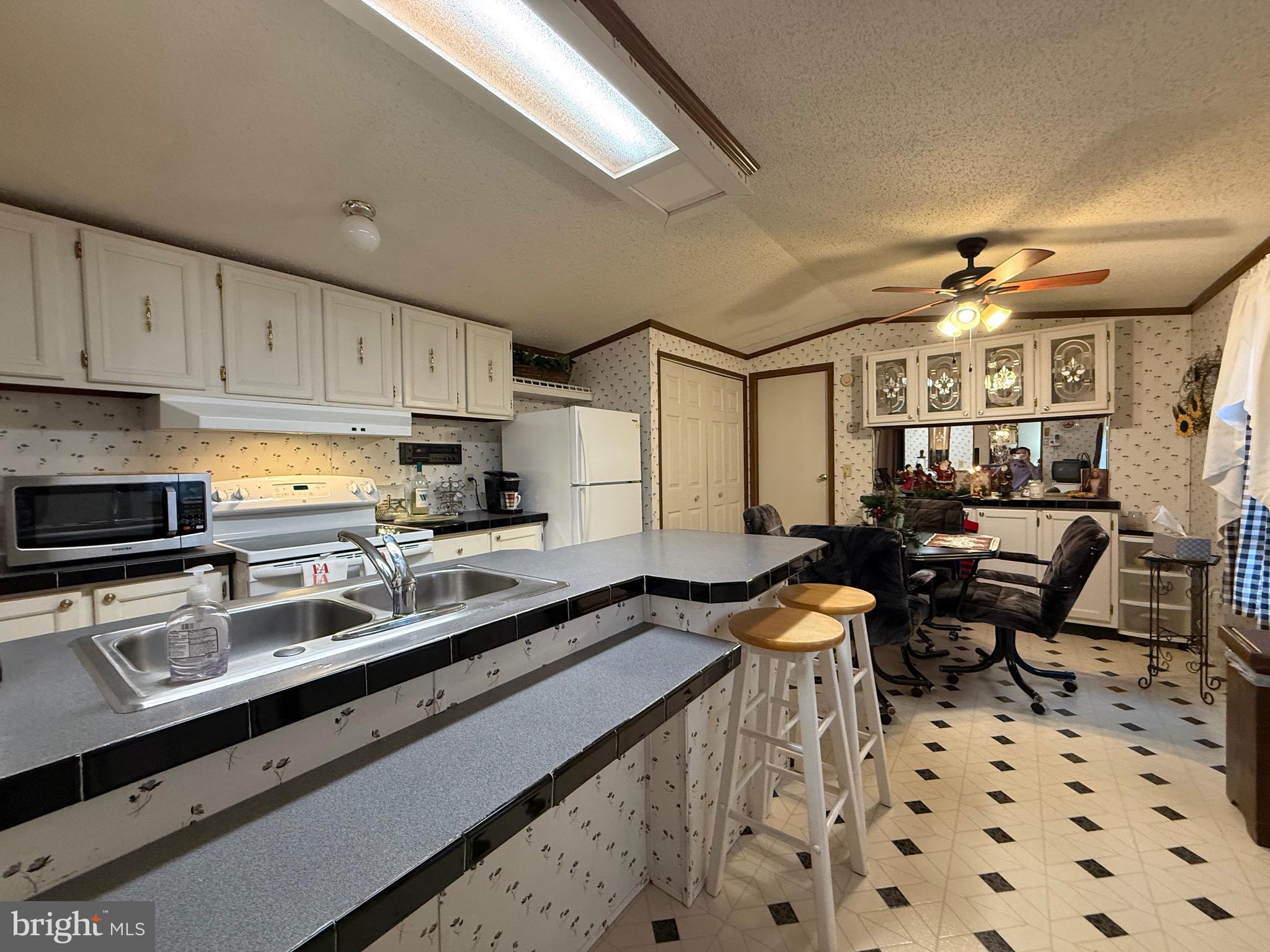 114 Pheasant Ridge Circle Lancaster, PA 17603 - Photo 9 of 24 a kitchen with stainless steel appliances a sink a stove a refrigerator and cabinets