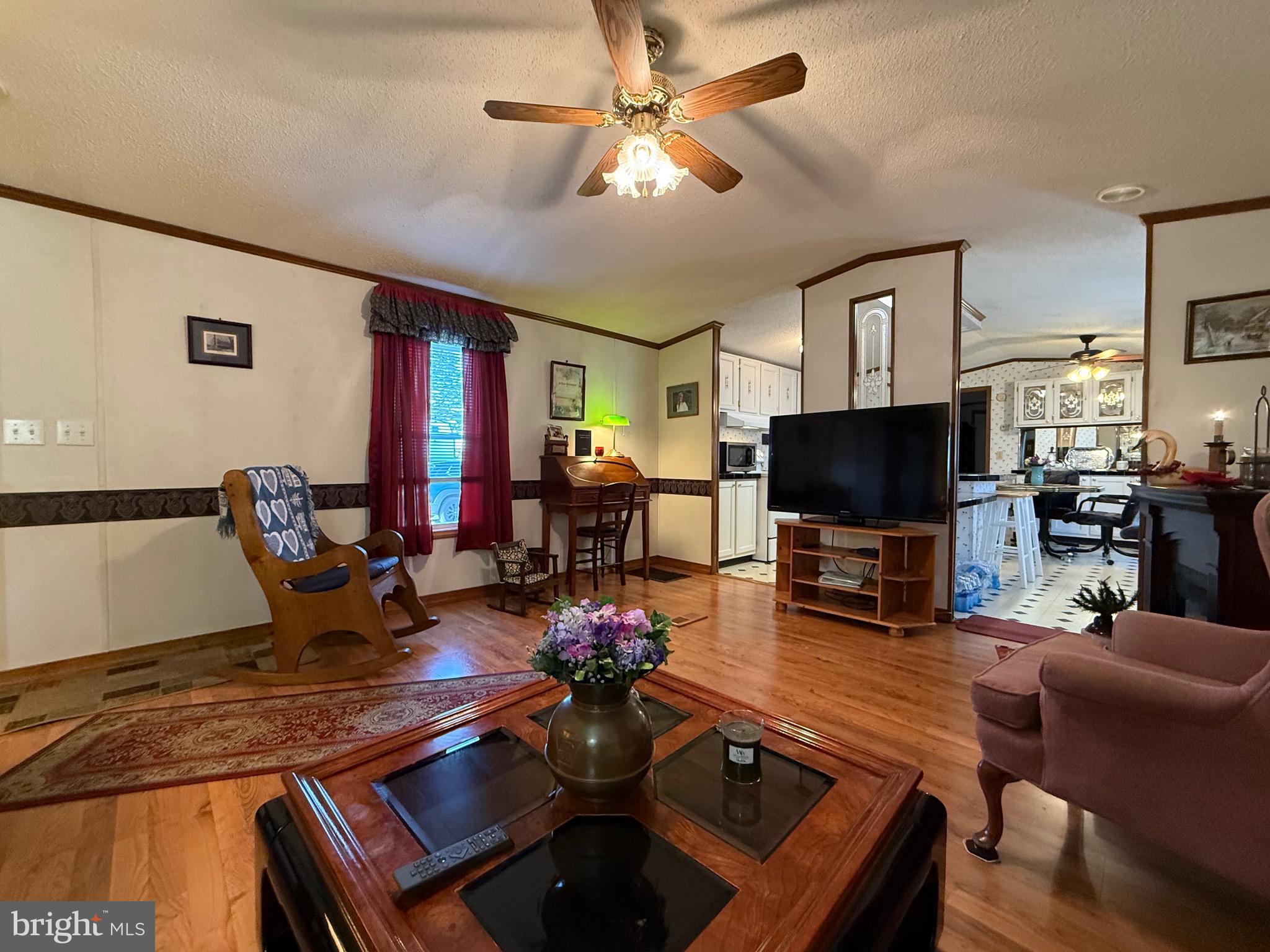 114 Pheasant Ridge Circle Lancaster, PA 17603 - Photo 10 of 30 a living room with furniture a flat screen tv and kitchen view