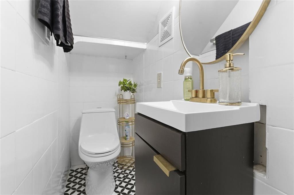 1336 4th Avenue Coraopolis, PA 15108 - Photo 11 of 50 a bathroom with a sink toilet and mirror