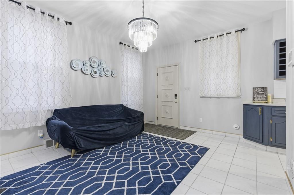 1336 4th Avenue Coraopolis, PA 15108 - Photo 16 of 50 a living room with a couch and a chandelier