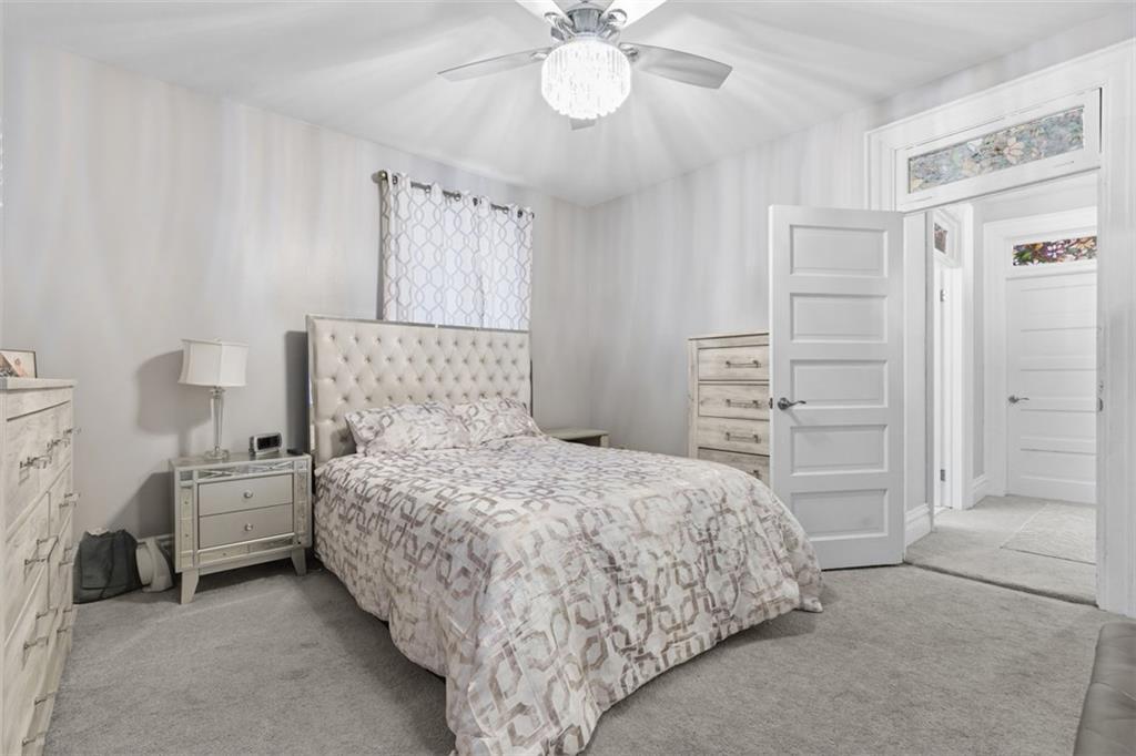 1336 4th Avenue Coraopolis, PA 15108 - Photo 19 of 50 a bedroom with a bed and a chandelier