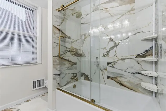 a bathroom with a bathtub and shower