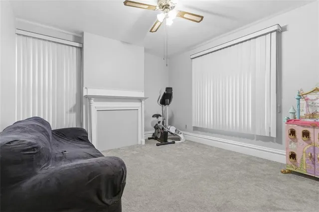 a living room with a bed furniture and a window