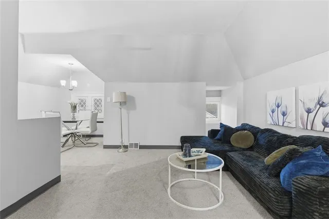a kitchen with stainless steel appliances granite countertop a sink and a refrigerator