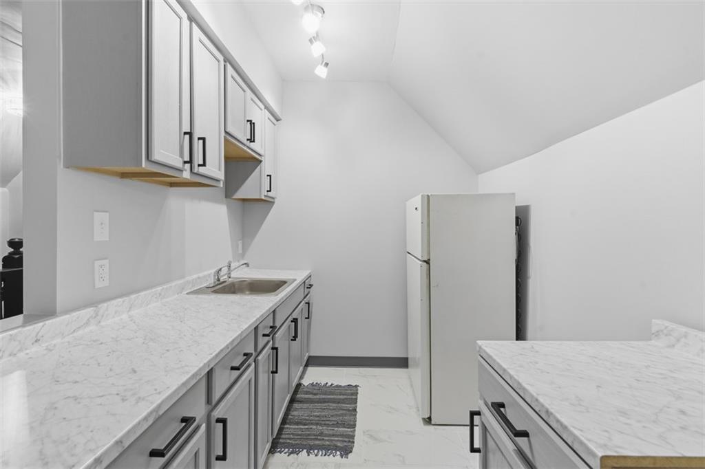 1336 4th Avenue Coraopolis, PA 15108 - Photo 31 of 50 a kitchen with stainless steel appliances granite countertop a sink and a refrigerator