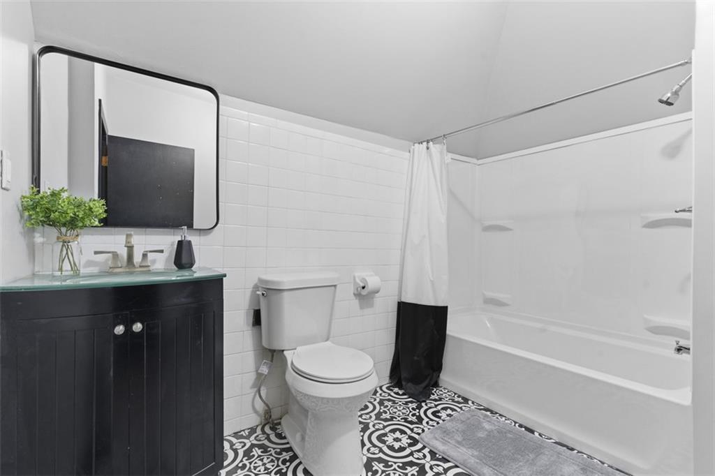 1336 4th Avenue Coraopolis, PA 15108 - Photo 35 of 50 a bathroom with a toilet sink and mirror