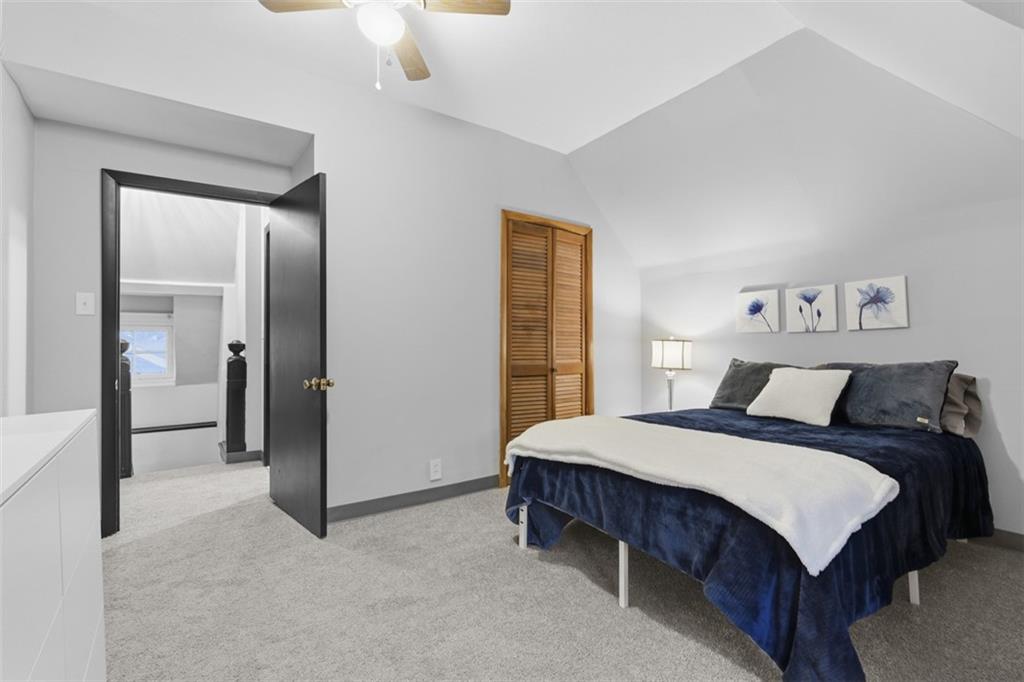 1336 4th Avenue Coraopolis, PA 15108 - Photo 36 of 50 a bedroom with a bed and a chandelier