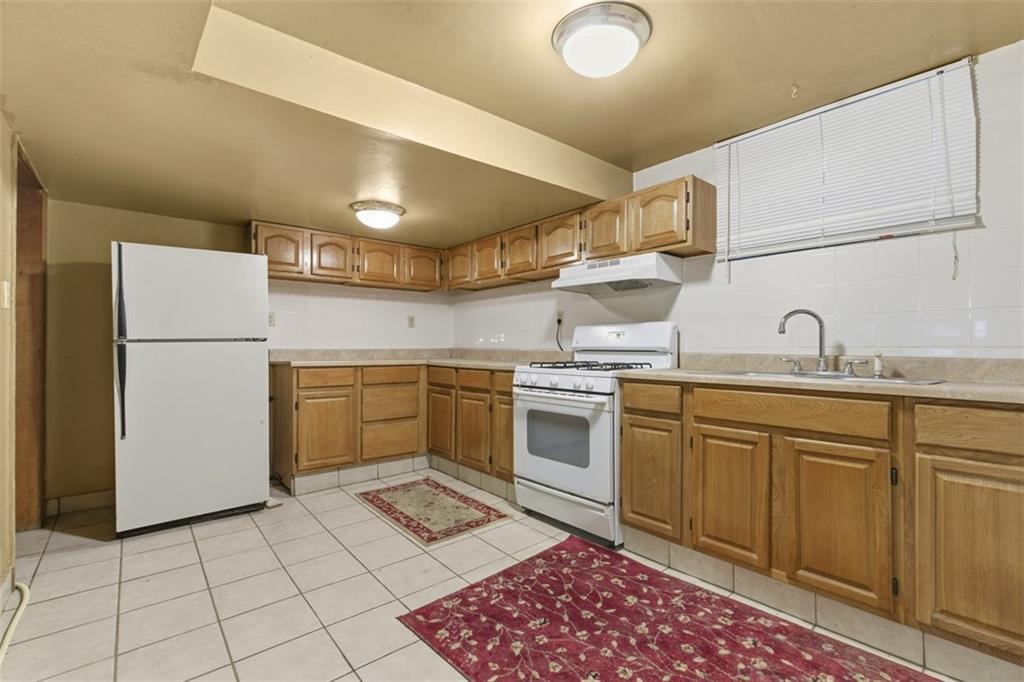 1336 4th Avenue Coraopolis, PA 15108 - Photo 41 of 50 a kitchen with a stove top oven and cabinets