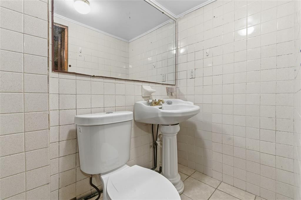 1336 4th Avenue Coraopolis, PA 15108 - Photo 44 of 50 a bathroom with a sink toilet and mirror