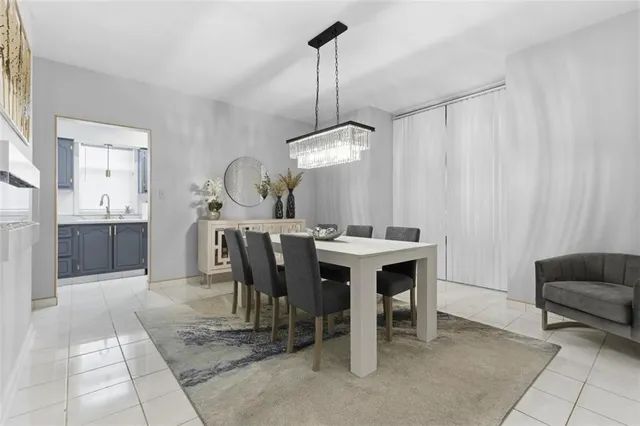 a view of a dining room with furniture and chandelier