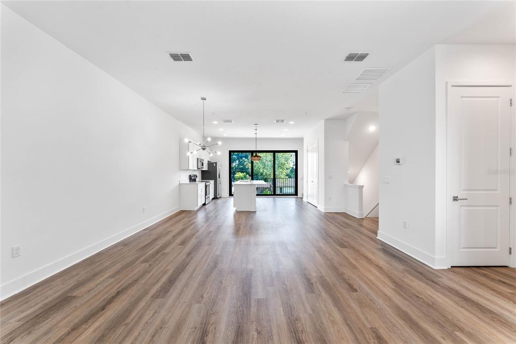 38 West Harding Street, Unit B Orlando, FL 32806 - Photo 13 of 27 a view of a big room with wooden floor and windows