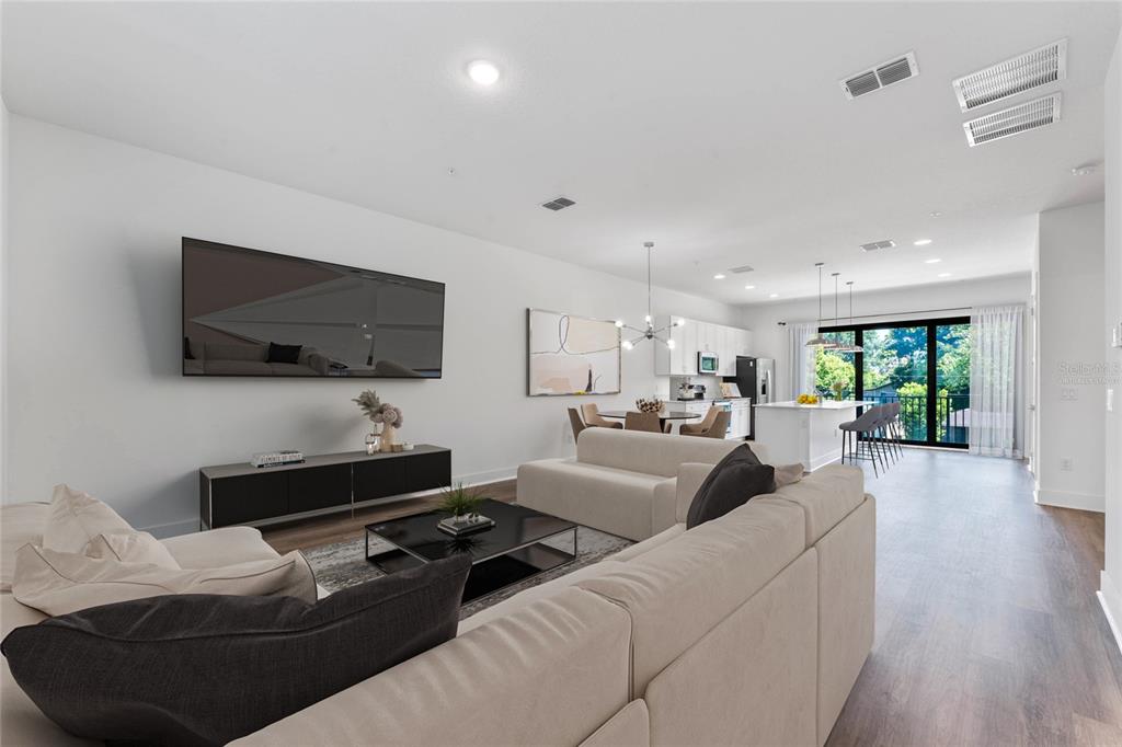 38 West Harding Street, Unit B Orlando, FL 32806 - Photo 5 of 27 a living room with furniture and a flat screen tv