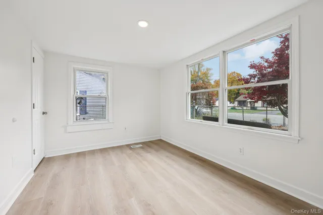 a view of a hallway with wooden floor and stairs