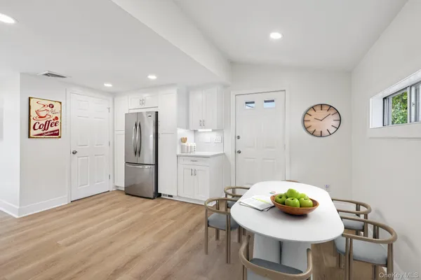 a kitchen with white cabinets and appliances