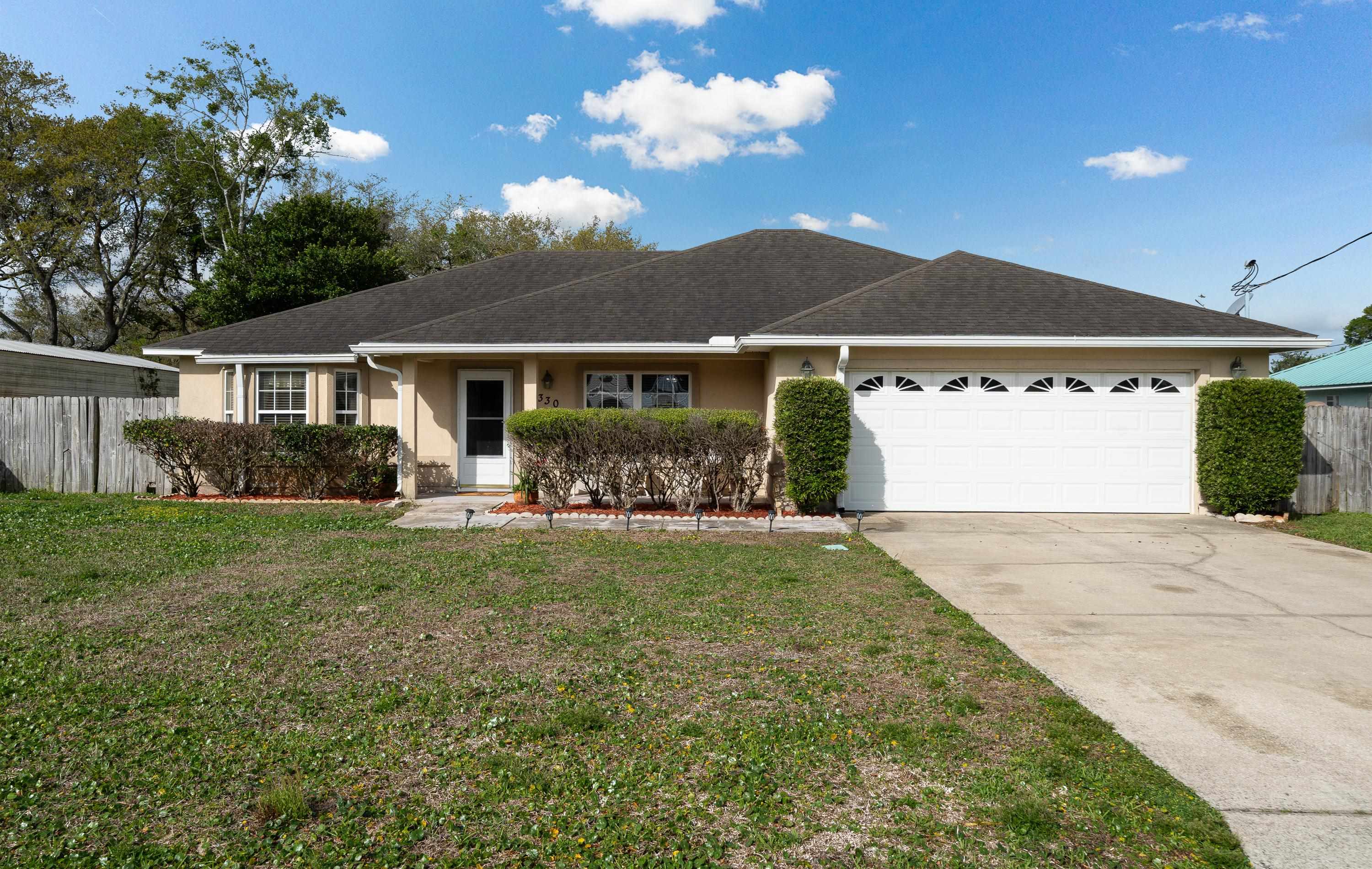 330 Segovia Road St. Augustine, FL 32086 - Photo 30 of 52 a front view of a house with garden