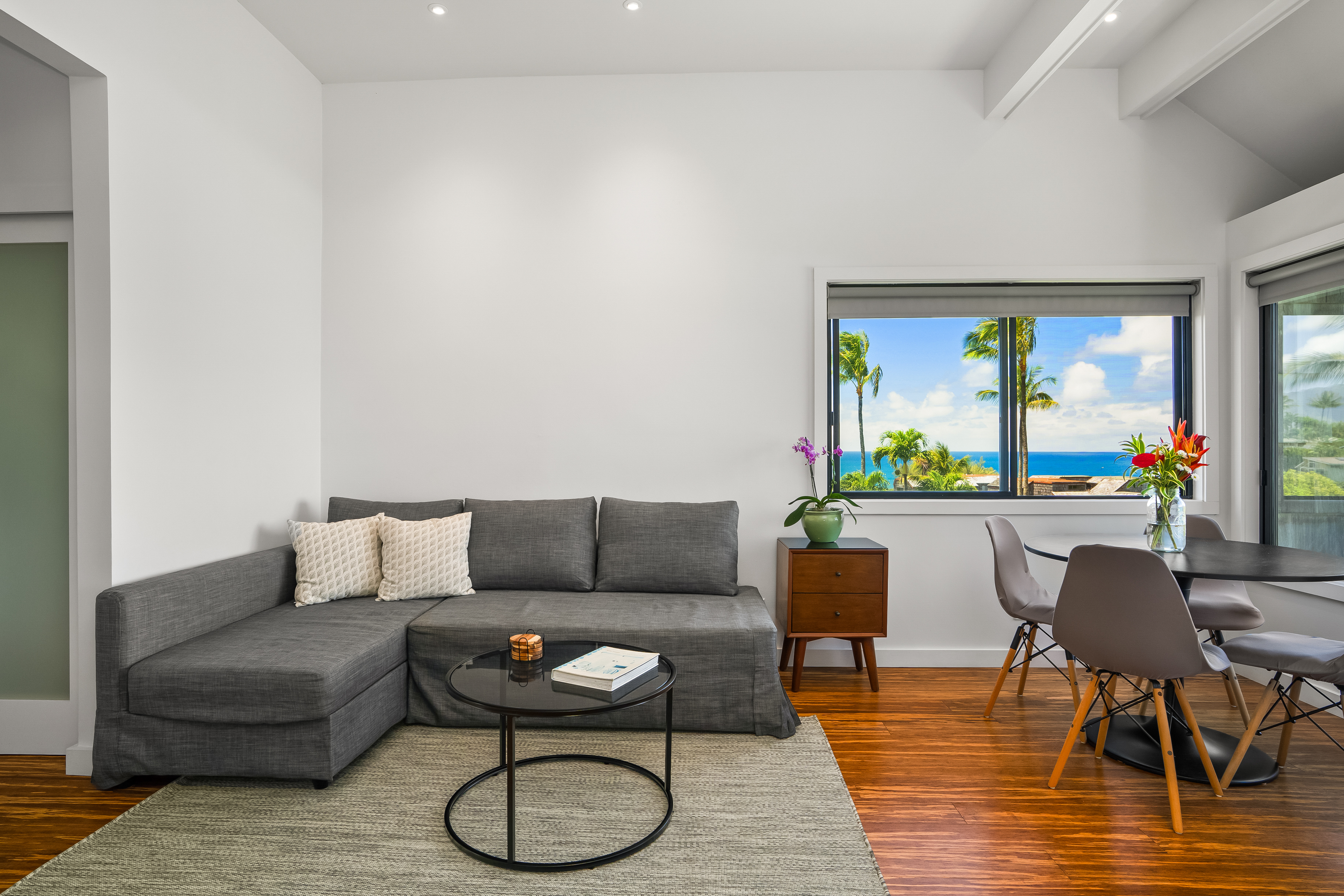 3700 Kamehameha Road, Unit F8 Princeville, HI 96722 - Photo 12 of 30 a living room with furniture and a floor to ceiling window
