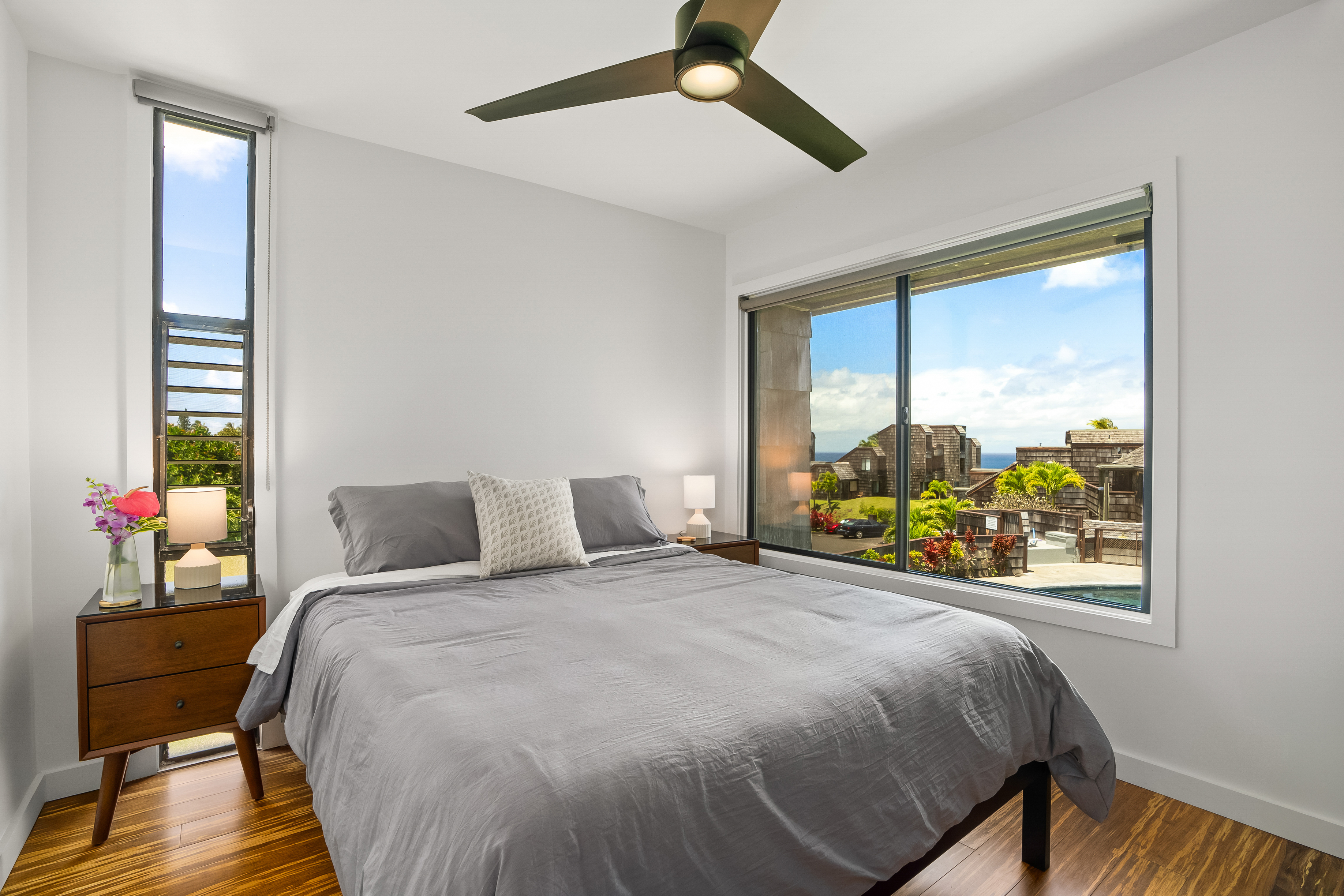 3700 Kamehameha Road, Unit F8 Princeville, HI 96722 - Photo 13 of 30 a bedroom with a bed and wooden floor