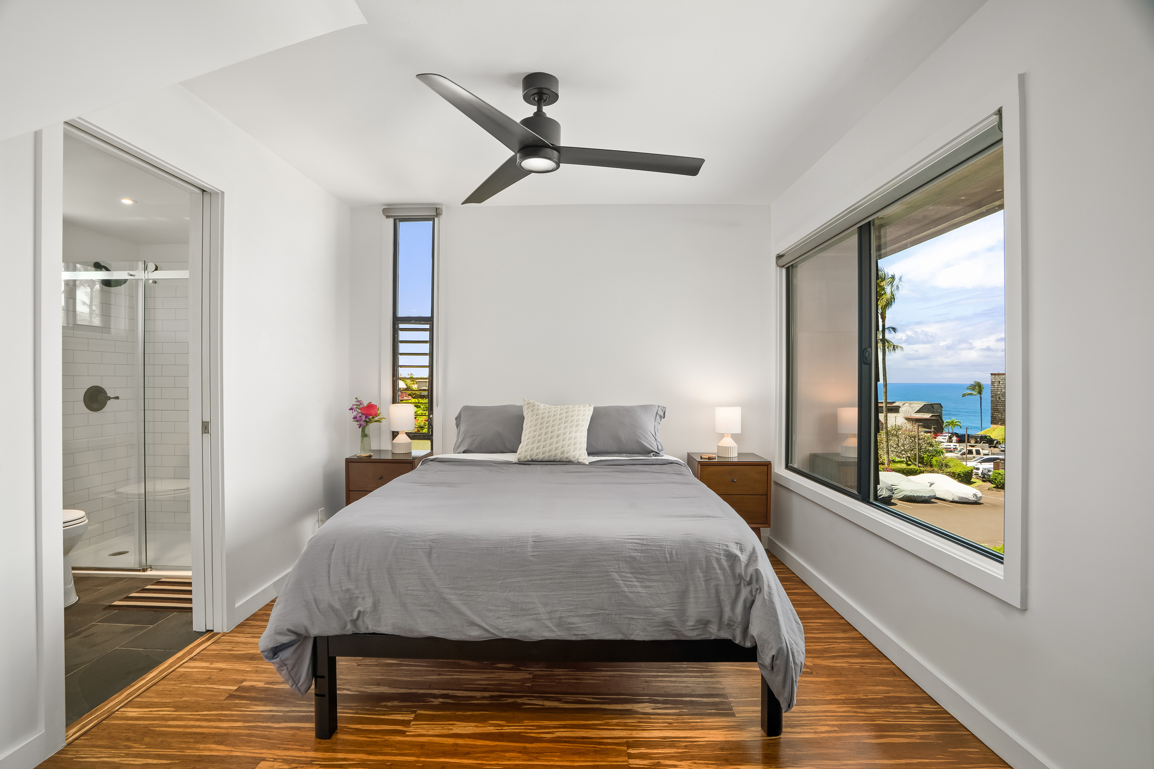 3700 Kamehameha Road, Unit F8 Princeville, HI 96722 - Photo 14 of 30 a bedroom with a bed and a large window