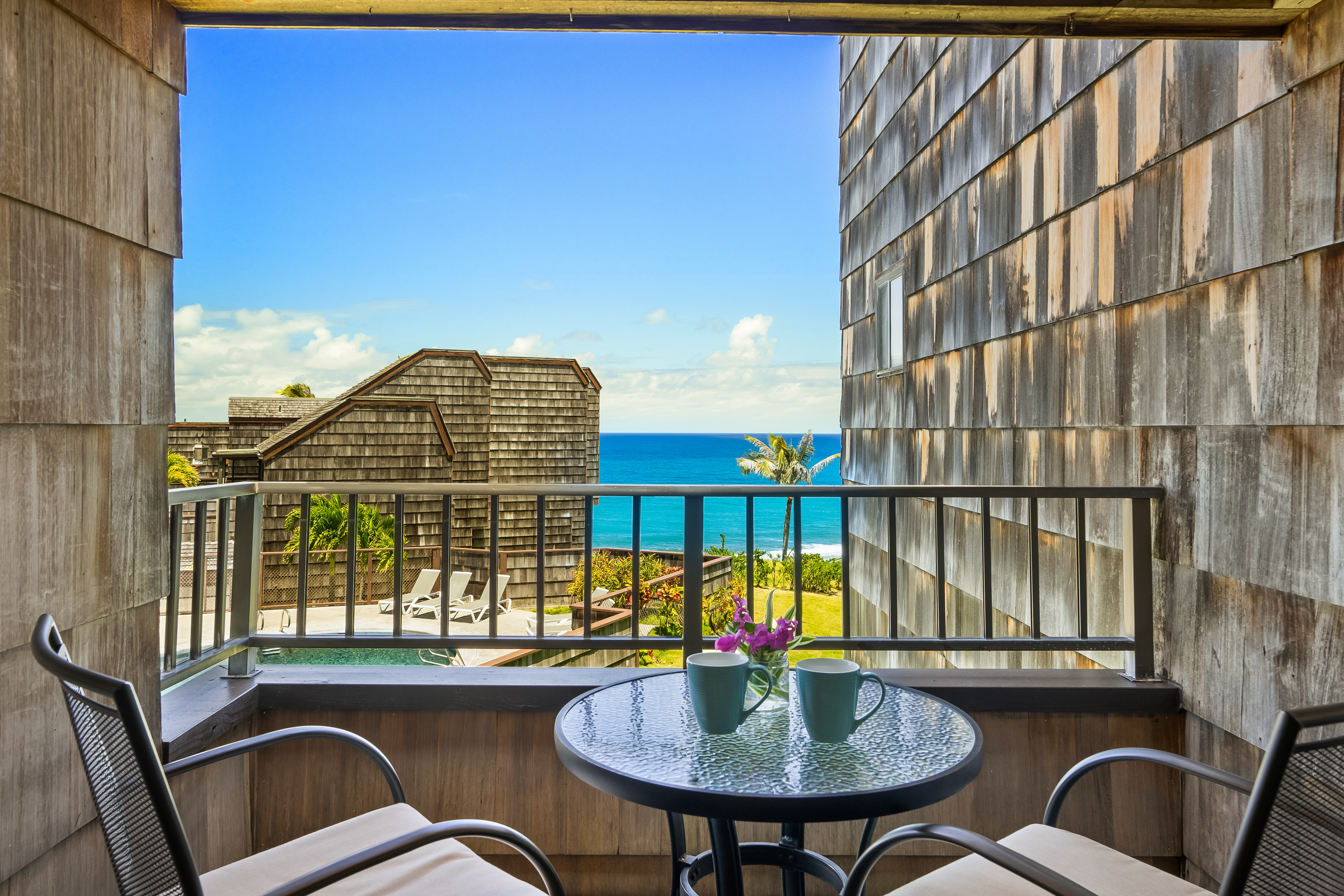 3700 Kamehameha Road, Unit F8 Princeville, HI 96722 - Photo 2 of 30 a view of a balcony dining table and chairs