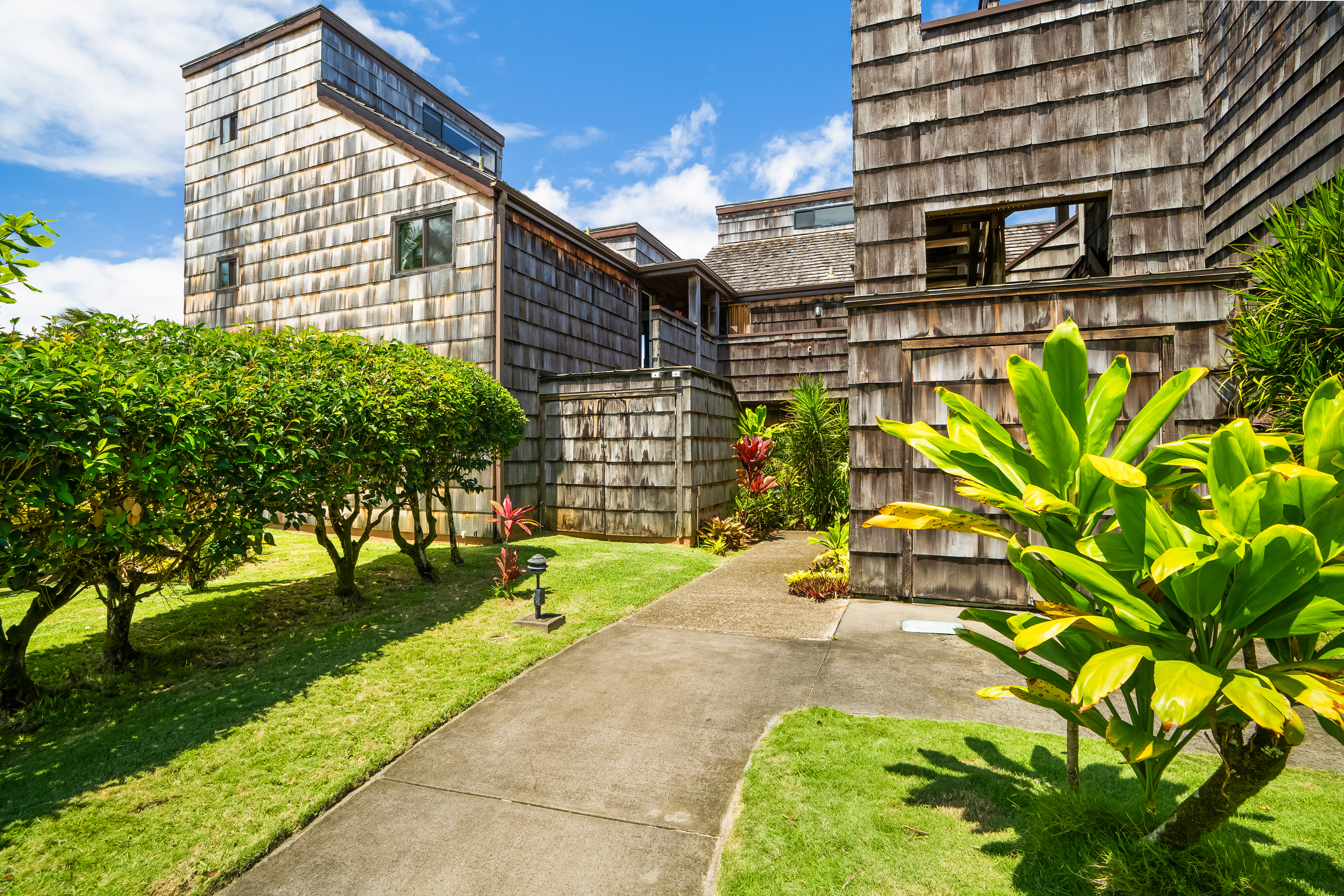 3700 Kamehameha Road, Unit F8 Princeville, HI 96722 - Photo 24 of 30 a front view of a house with a yard