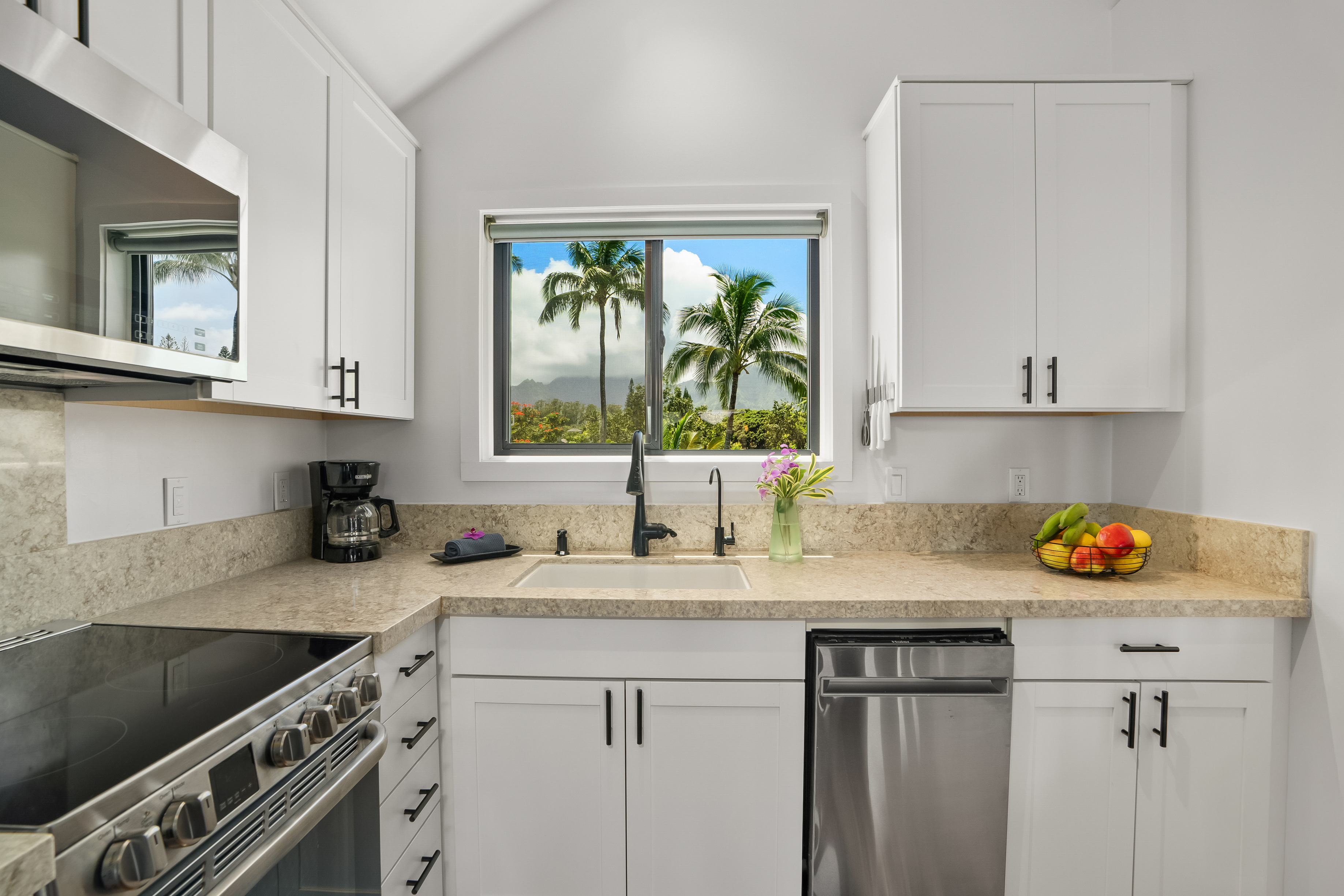 3700 Kamehameha Road, Unit F8 Princeville, HI 96722 - Photo 8 of 30 a kitchen with stainless steel appliances granite countertop a sink stove and cabinets